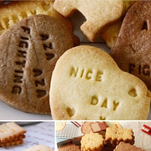 Detail of DIY baking cookies with embossed letters and motivational words on brown shapes
