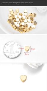 Macro shot of 5mm golden heart-shaped metal beads with 1mm hole for DIY jewelry making