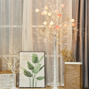 Illuminated birch tree lights with warm LEDs and pink and white globes for home decor