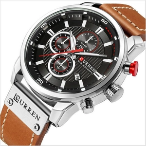Macro detail of Curren men's quartz watch showing black dial and brown leather strap texture