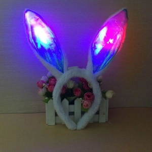 Close-up of LED glowing bunny ear headband with blue fluorescent lights and plush texture