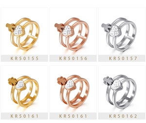Detail view of hollow double-layer heart rings with boy and girl charms in gold and silver