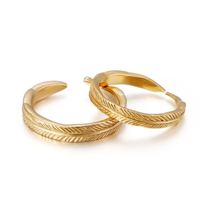 Adjustable golden feather rings in vintage bohemian style for couples on white background