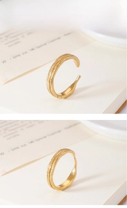 Macro detail of golden feather texture and adjustable opening on the minimalist ring