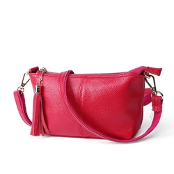 Detail of rose red lychee grain leather purse with matching tassel and metal zipper