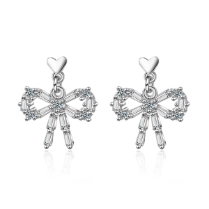 Elegant silver bow and heart stud earrings with sparkling cubic zirconia on white background