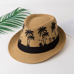 Detail of woven straw fedora featuring a coconut tree print ribbon for summer vacations