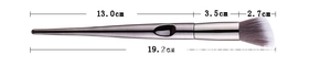 Detail view of makeup brush showing ergonomic silver handle and precise size measurements