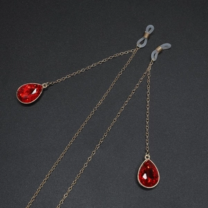 Golden eyewear chain with anti-slip silicone loops and red teardrop crystal pendants