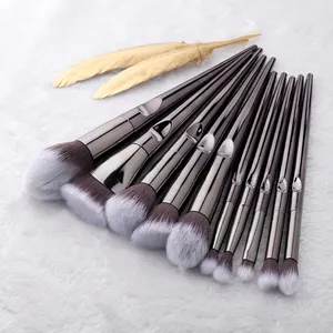 Detail of 12-piece makeup brush set with gradient bristles on soft white plush background