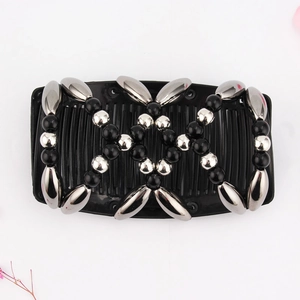 Detail of magic hair comb with black and silver beads on a flexible mesh base