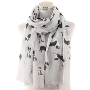 Light gray long scarf with cute dog prints and tassel trim on a studio mannequin