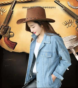 Detailed view of a brown suede cowboy hat with stitched brim and blue denim jacket