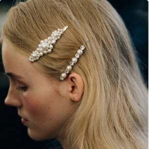 Detail showing two-piece hair clip set with elegant pearls and sparkling rhinestones