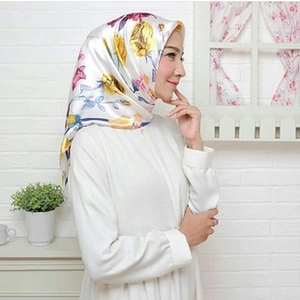 Detail of a 90x90cm satin square scarf with yellow floral and carriage chain print
