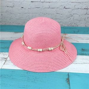Pink women's summer sun hat with woven beads and a small bow detail for UV protection
