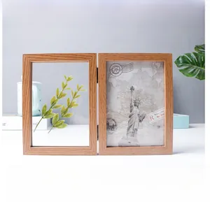 Detail view of a double folding wooden photo frame with vintage decorative inserts