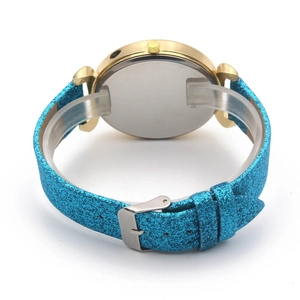 Detail view of the blue glitter strap and golden case back of this women's watch