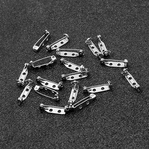 Close-up of silver stainless steel safety brooch pins with holes for DIY craft jewelry