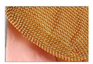 Detail view showing bottom texture of golden beaded woven evening clutch bag