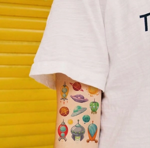 Cartoon space temporary tattoos for kids featuring colorful rockets and UFOs on arm