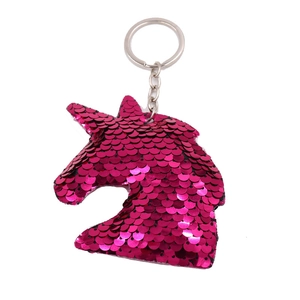 Detail of pink sequin unicorn keychain with metallic ring on a white background