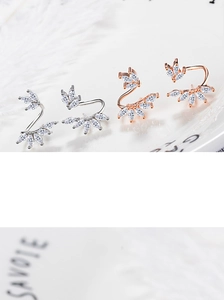 Macro detail of leaf earrings with marquise cubic zirconia in silver and rose gold