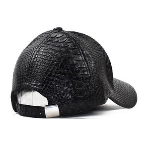 Detail of black faux leather baseball cap showing crocodile texture and adjustable metal buckle