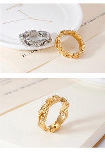 Detailed relief of vintage rose rings in gold and silver finishes on elegant decor