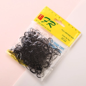 Retail packaging of black TPU elastic hair bands for girls with vibrant pink background