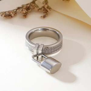 Polished silver ring with double row of zircons and a small padlock charm pendant