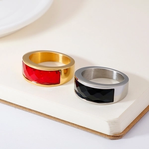 Vintage style rings with red and black faceted crystals on an open book background