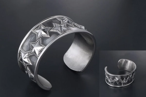 Detailed view of punk star pattern on wide silver titanium steel cuff bracelet