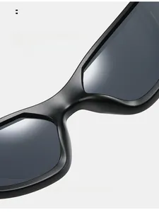 Macro view of matte black sunglasses featuring integrated comfortable nose pads and grey lens