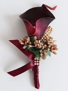 Detail of handmade deep purple PU calla lily boutonniere with gold accents and ribbons