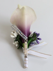Detail view of white and purple calla lily boutonniere with rhinestone ribbon and pin