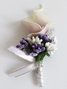 Detail of lavender PU calla lily boutonniere with decorative purple filler and gold-edged ribbon