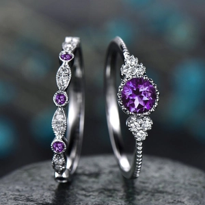 Macro detail of two-piece sterling silver ring set with round purple gemstone and zircon