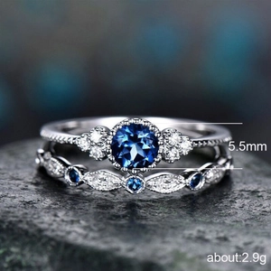 Macro view of silver ring set with 5.5mm blue zircon and marquise-cut stones