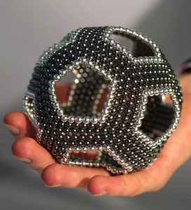 Handheld view of a 3D geometric shape made from 5mm silver and black magnetic buckyballs