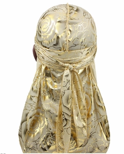 Detailed back view of a golden silky durag with floral rose print and long tail ties