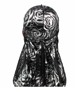 Detail showing back view of silky black durag featuring intricate silver rose patterns