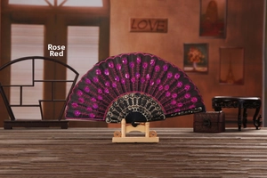 Detail of rose red sequins and floral embroidery on a black vintage folding fan