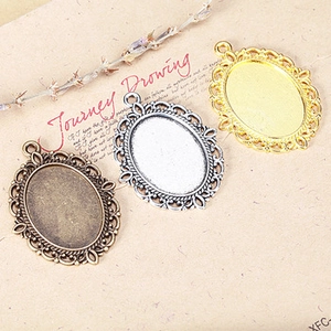 Detail of vintage carved skull rose pendants in antique bronze, silver, and gold finishes