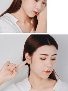Detail view of silver leaf stud earrings with sparkling zircon crystals on a female model