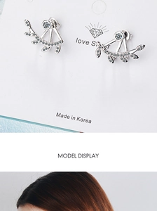 Detail of silver leaf earrings with sparkling zircons and delicate branch design