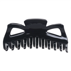 Detail of glossy black hollow-out hair claw clip with strong teeth for thick hair