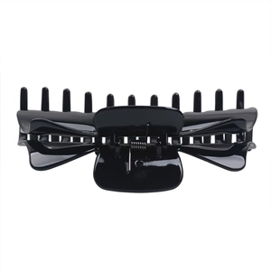 Close-up of durable black glossy hair claw clip featuring strong metal spring and teeth