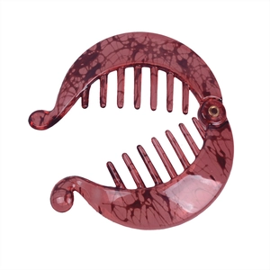 Detail of dark red marble texture banana hair clip with interlocking teeth design