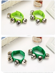 Detail of green Orff wrist bells with four silver metal bells and adjustable velcro strap